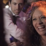 woman at wedding reception dancing and smiling on dance floor